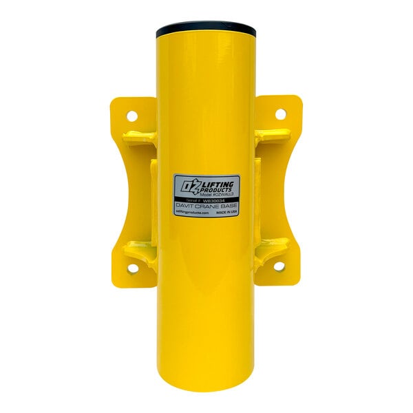 A yellow metal cylinder with black text, the OZ Lifting Products Wall Mount Base for a steel davit crane.