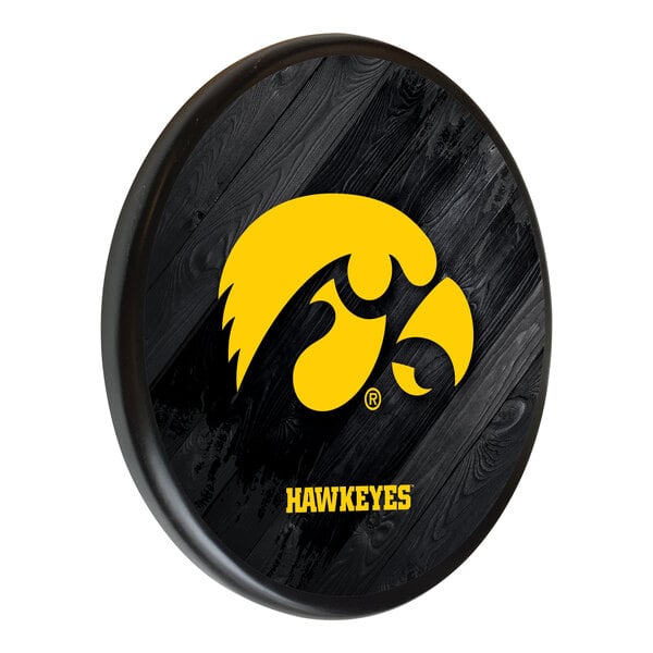 A black wooden round plate with the University of Iowa Hawkeyes logo in yellow.