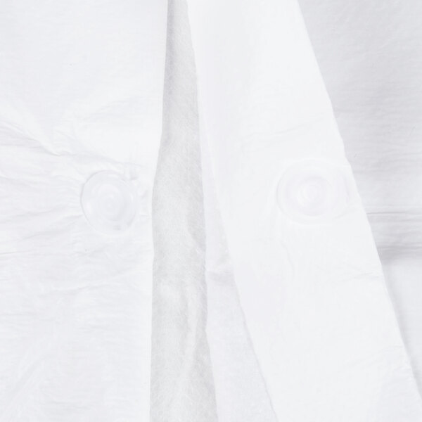 A close up of a white Cordova microporous lab coat with buttons.