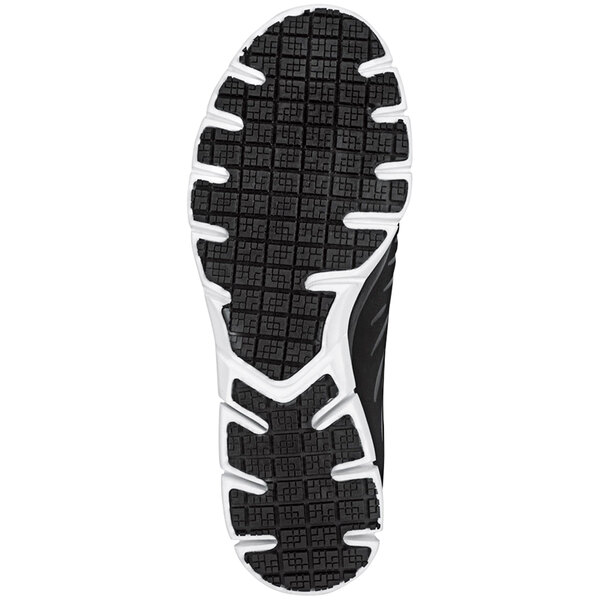 A close-up of the sole of a black and white Skechers Work Stacey athletic shoe.