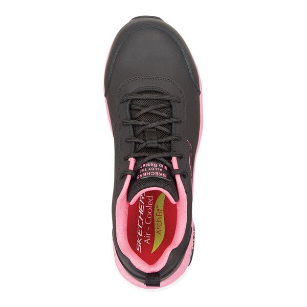 A women's black and pink Skechers athletic shoe with an alloy toe and non-slip sole.