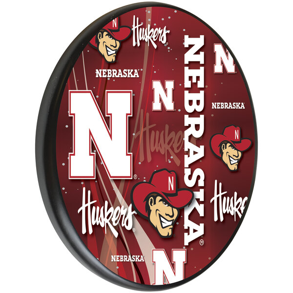 A red wooden sign with a white University of Nebraska logo and text.