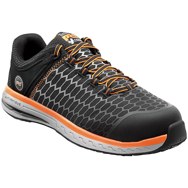 A black and orange Timberland PRO Powerdrive men's work safety shoe with a composite toe.