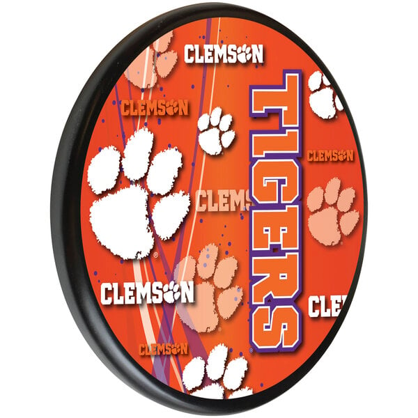 A orange wooden sign with the Clemson University logo in white and purple.