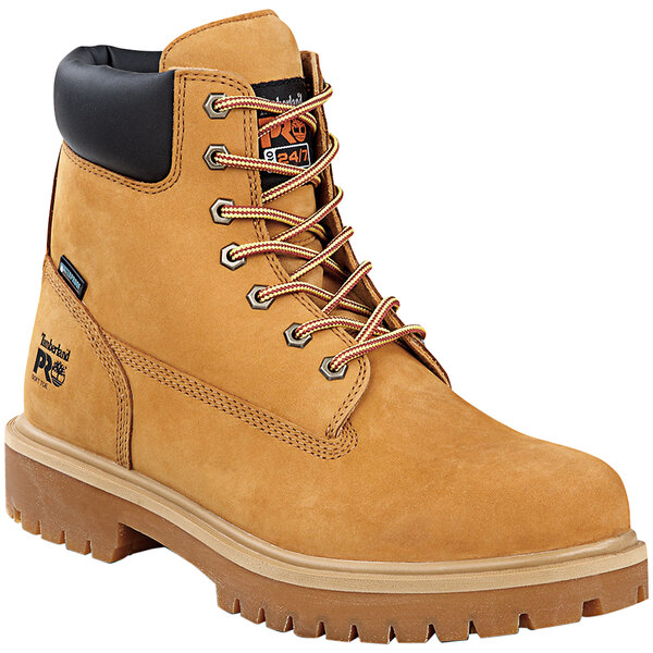 A brown Timberland PRO steel toe leather boot with black laces and a black sole.