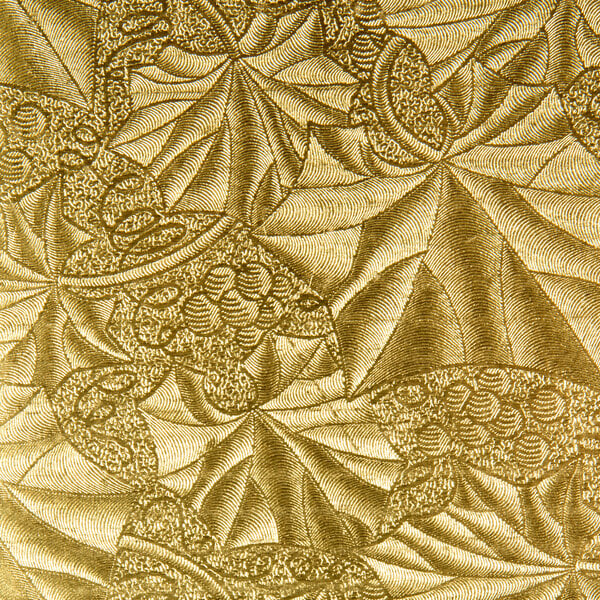 A white and gold patterned Enjay half sheet cake board.