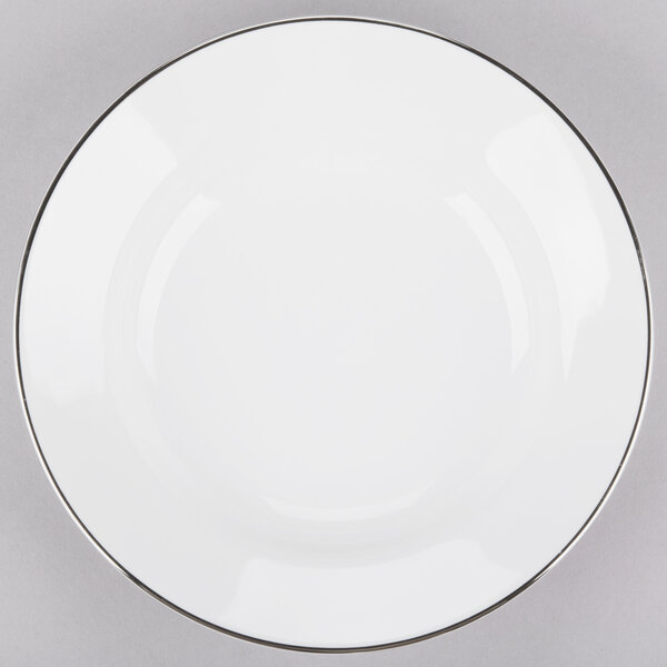 A white porcelain soup bowl with a silver rim.