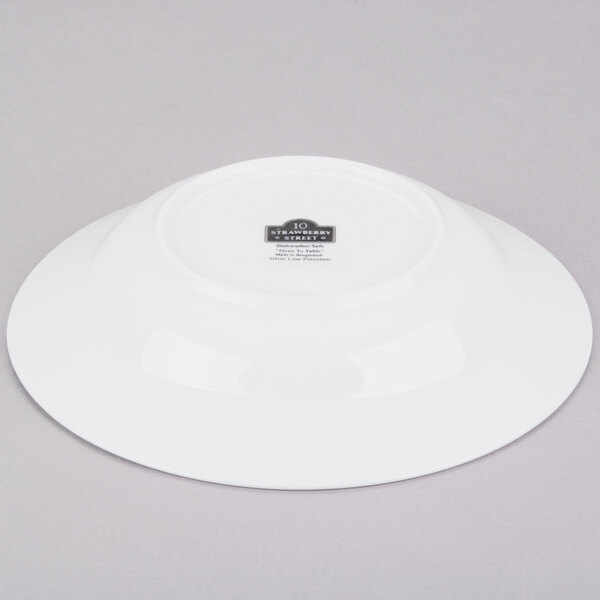 A white porcelain soup bowl with a silver rim.