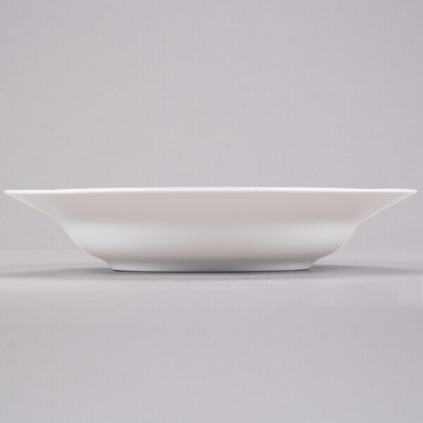 A white bowl on a grey surface.