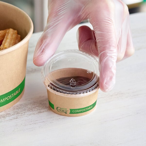 A small round compostable take-out container with a clear lid, labeled as EcoChoice.