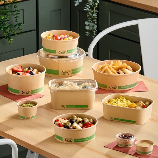 A variety of compostable brown paper food containers and lids displayed on a table, some filled with different foods.