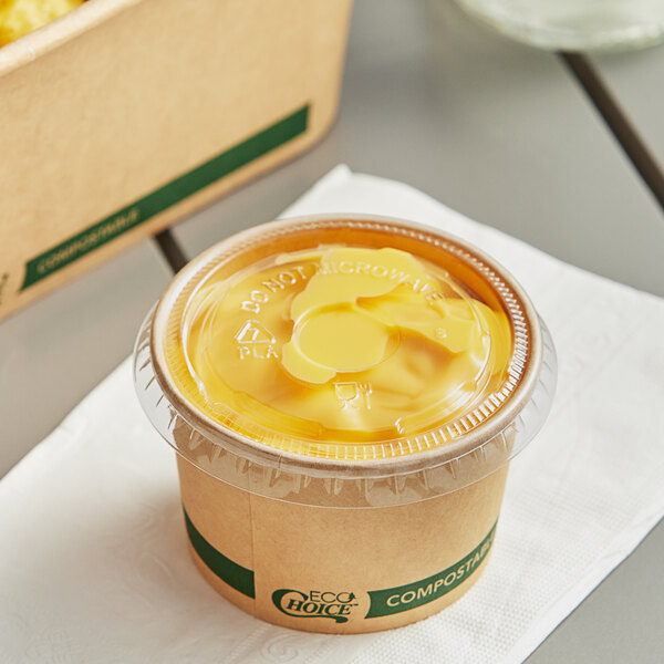 A container of food with an EcoChoice compostable lid on a table.