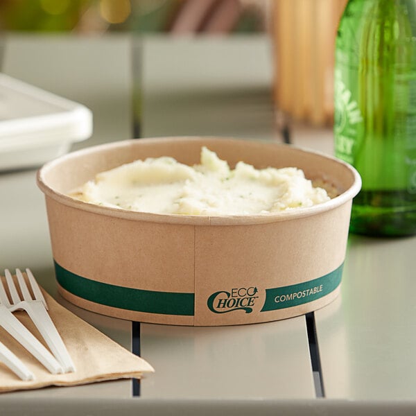 A EcoChoice round paper take-out container filled with mashed potatoes on a table.