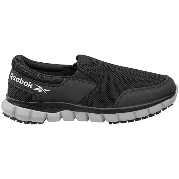 A black Reebok slip-on athletic shoe with a white sole.
