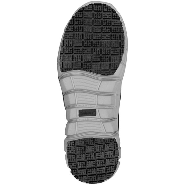 The black and gray rubber sole of a Reebok Work slip-on shoe.