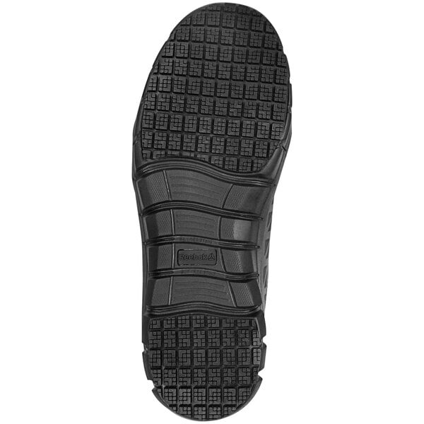 The rubber sole of a Reebok Work black athletic shoe.