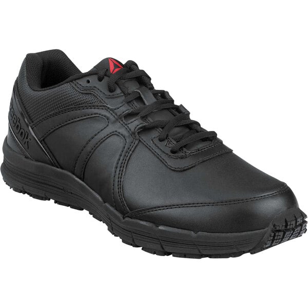 A black Reebok men's athletic shoe with a red logo.