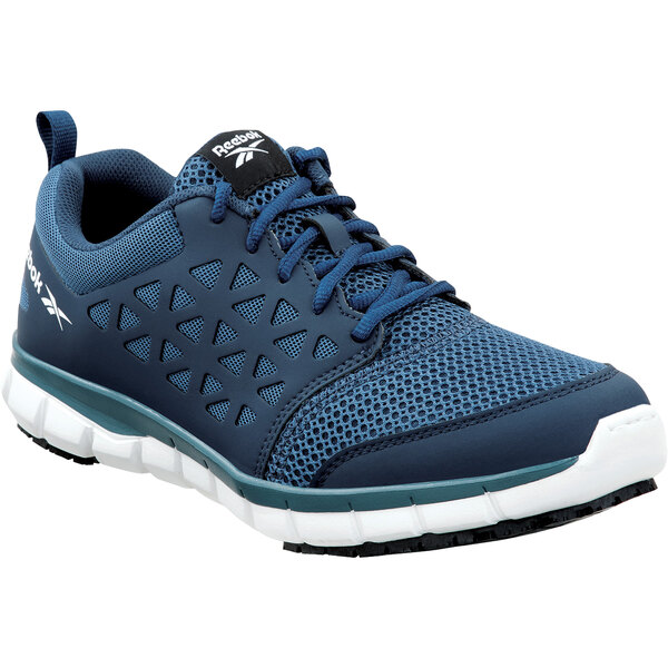 A close up of a Reebok Work Sublite men's navy blue and white athletic shoe.