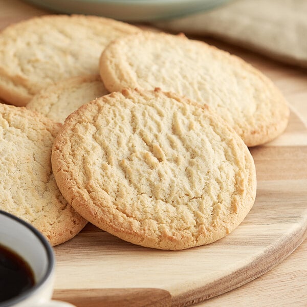 A wooden board with Best Maid Thaw and Serve sugar cookies on it.