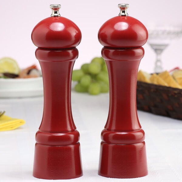 A Chef Specialties candy apple red salt and pepper mill set on a table.