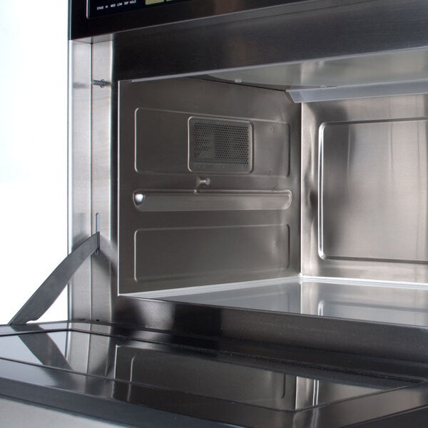 A Panasonic Sonic Steamer commercial microwave oven with the door open and a tray inside.