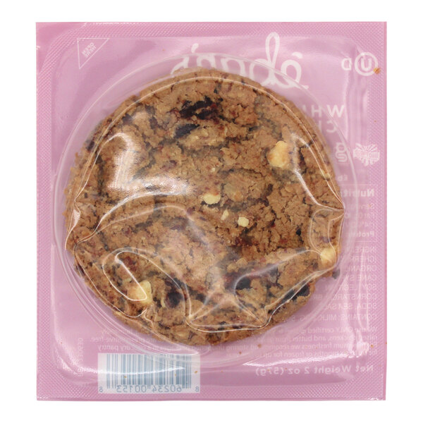 An Eban's Bakehouse gluten-free white chocolate cherry oatmeal cookie in plastic wrap.