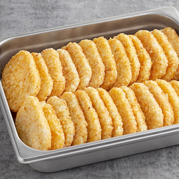 Simplot Hash Brown rectangle patties in a metal pan on a table.