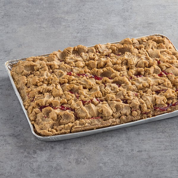 A rectangular Hahn's Bakery German Crumb Cake with raspberries on top.