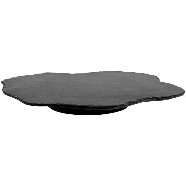 A black limestone lazy susan with a black circle on top.