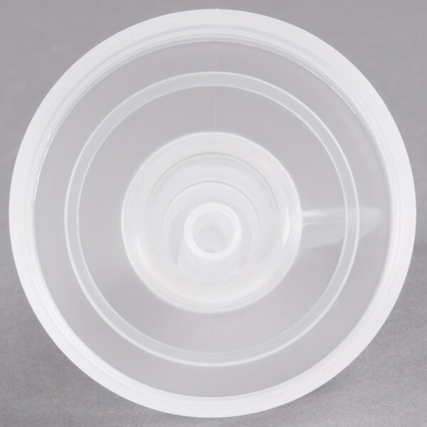 A close-up of a white GET lid for plastic salad dressing bottles.