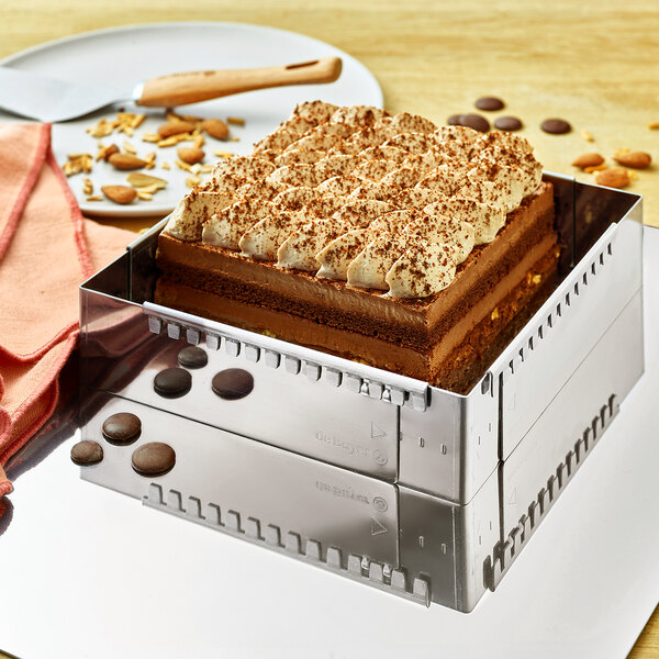 A cake in a de Buyer stainless steel expandable square pastry frame.