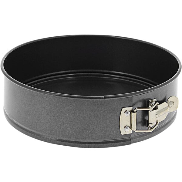 A round black metal de Buyer springform cake pan with a metal handle.