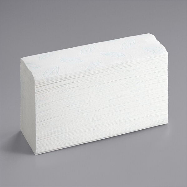 A stack of Tork Premium Xpress white multi-fold paper towels.