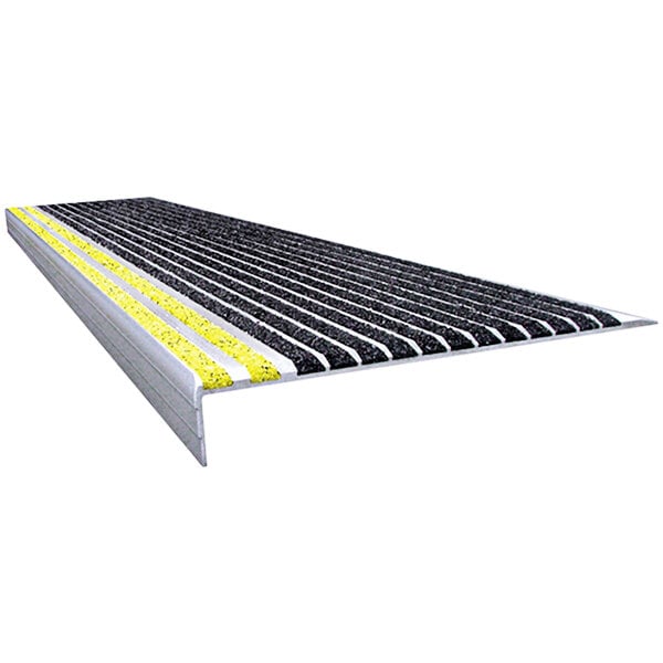 A close-up of a Wooster black and yellow stair tread with yellow striped grit.