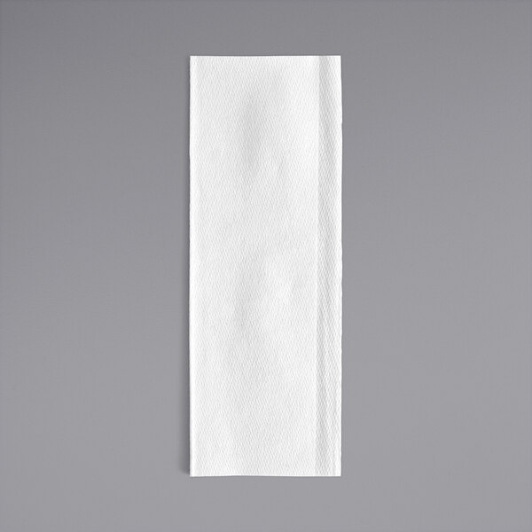 A Tork white multi-fold paper towel on a gray background.