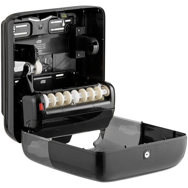 A black plastic box with a Tork Elevation Matic paper towel dispenser inside.
