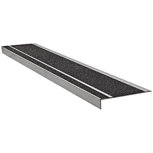 A close-up of a Wooster Flexmaster Stair Tread with black and silver grit surface.