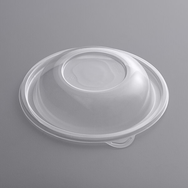 A clear plastic lid on a white surface.