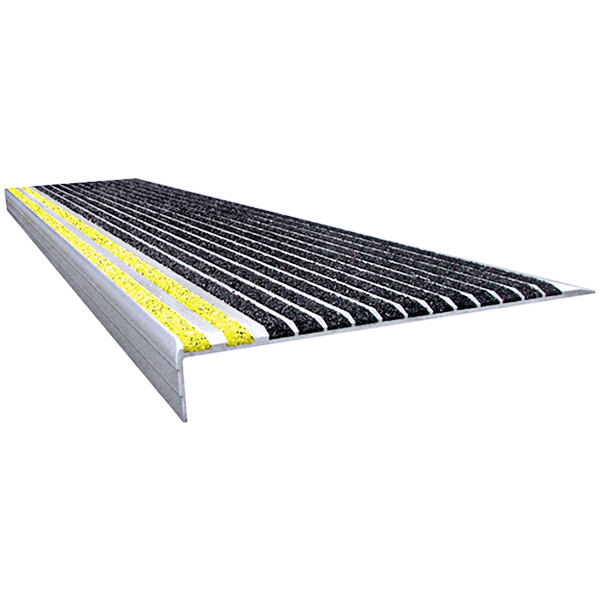 A black Wooster Stairmaster stair tread with yellow and black striped surfaces.