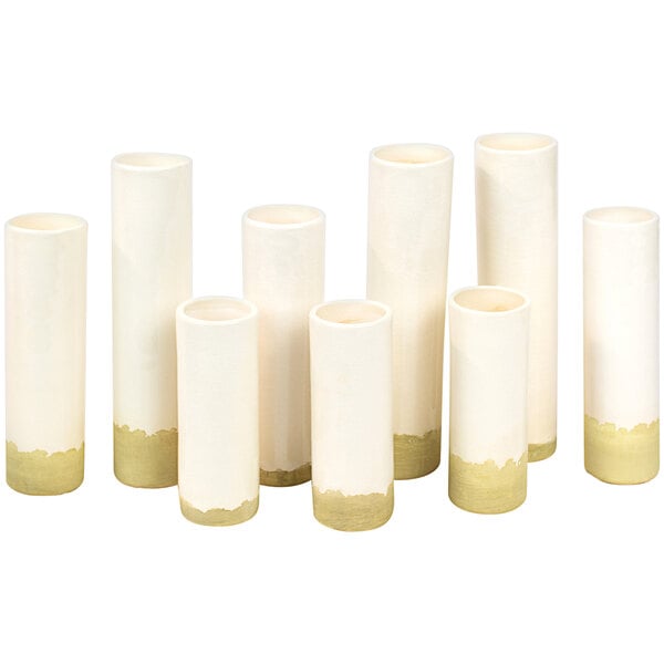 A group of white Kalalou bud vases with gold trim.