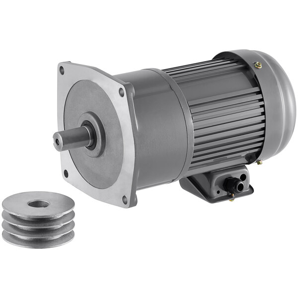 A grey electric motor with a round metal disc.