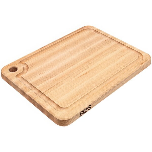 A John Boos maple wood cutting board with a handle.