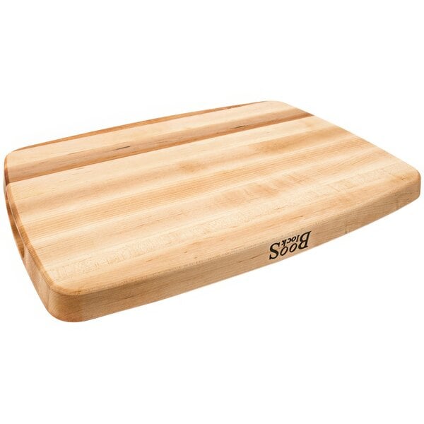 A John Boos maple wood cutting board with a grooved and reversible surface.