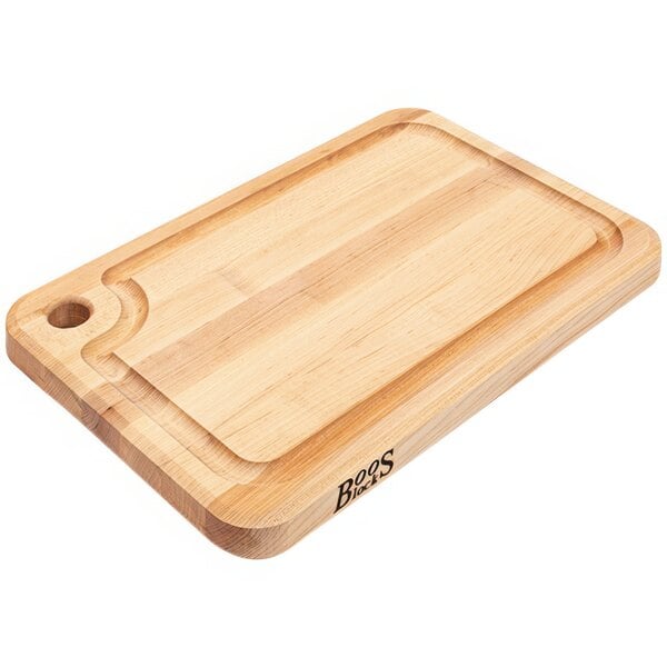 A John Boos maple wood cutting board with a handle.