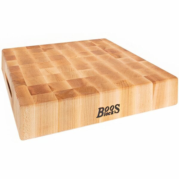 A John Boos maple wood chopping block with a square pattern on it.