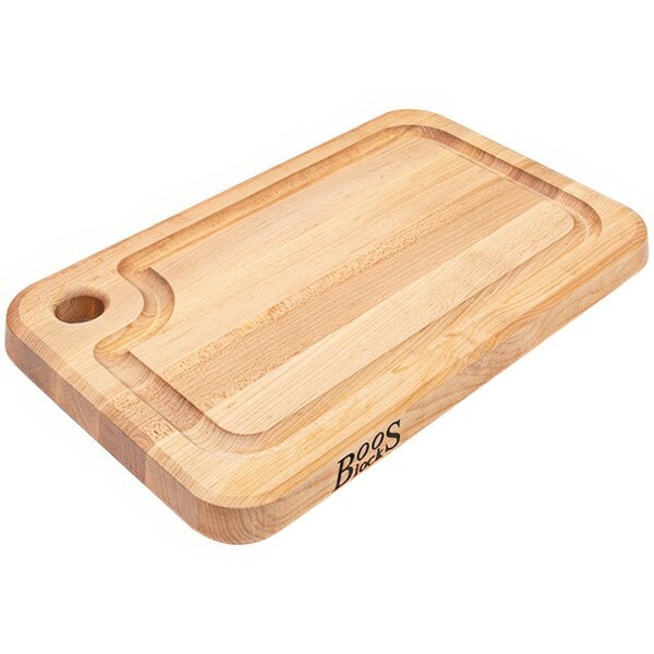 A John Boos maple wood cutting board with a handle.