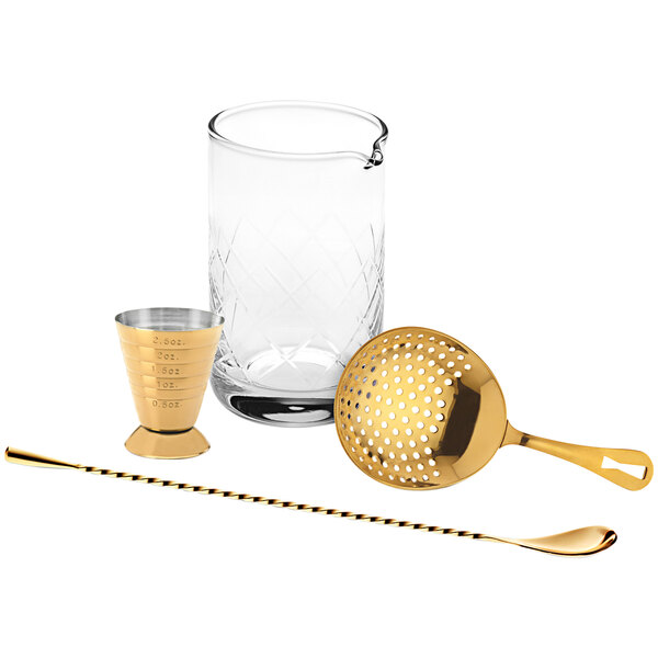 A gold Barfly cocktail mixing kit on a white background including a strainer, shaker, and bar spoon.