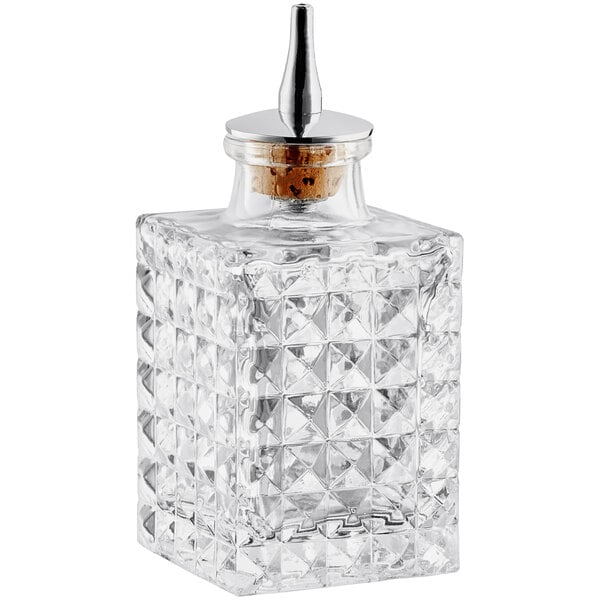 A Barfly glass bitters bottle with a metal lid.