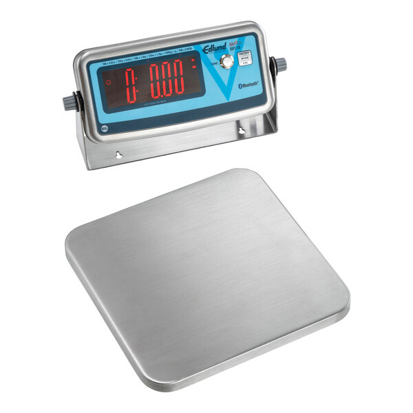 An Edlund wireless digital pizza scale with a stainless steel surface.