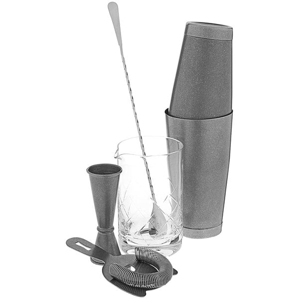 A Barfly vintage cocktail mixing kit on a counter with a shaker, glass, and spoon.